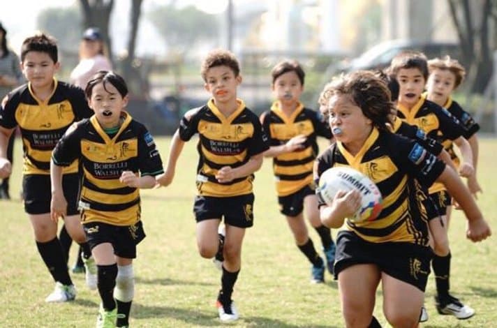 USRC Tigers mini rugby players running with the ball
